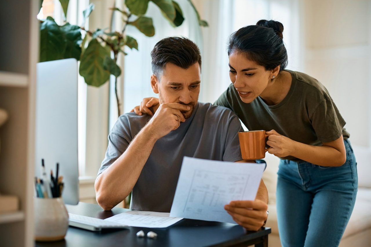 mid-adult-couple-analyzing-their-home-finances-at-home-